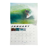 calendar of january and photo of Brett Simpson surfing a wave
