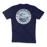 A navy blue short-sleeve t-shirt shown from the back, featuring a large circular graphic print on the center back. The graphic depicts a lifeguard tower over blue water with the text 'HUNTINGTON BEACH LIFGUARD' in white and blue, and 'HB CA' on the sides.