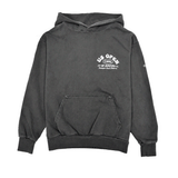 Front view of a charcoal heavyweight hooded sweatshirt featuring a white US Open of Surfing logo on the left chest. The pullover hoodie includes a kangaroo pocket, ribbed cuffs and waistband, and a vintage-washed finish, displayed on a clean white background.