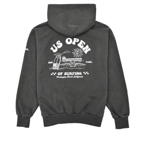 Back view of a charcoal heavyweight hooded sweatshirt featuring a large white US Open of Surfing graphic with a surfboard, ocean waves, sun illustration, and Huntington Beach Pier artwork. The pullover hoodie has a vintage-washed finish, ribbed cuffs and waistband, and is displayed on a clean white background.