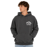 Front view of person wearing a charcoal heavyweight hooded sweatshirt featuring a white US Open of Surfing logo on the left chest. The pullover hoodie includes a kangaroo pocket, ribbed cuffs and waistband, and a vintage-washed finish, displayed on a clean white background.