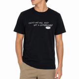 person wearing black t shirt with text across the chest "CAN'T WE ALL JUST GET A LONGBOARD?" on white background