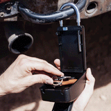 opened lock with keys in side lock compartment. lock is attached to car