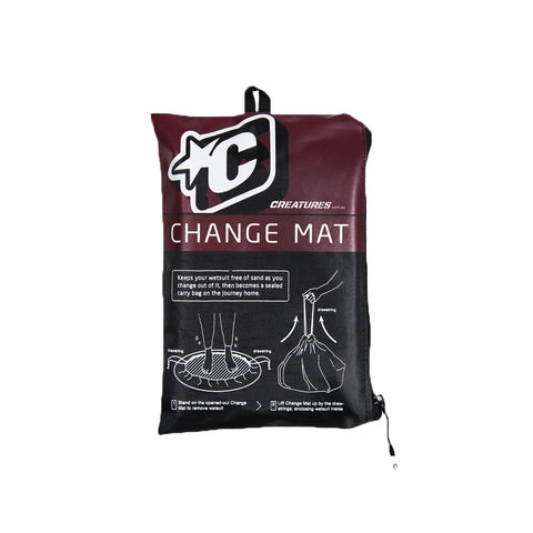 Change mat packaging with 'Creatures' logo on a wooden surface