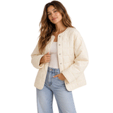 woman wearing bone colored jacket with button closure