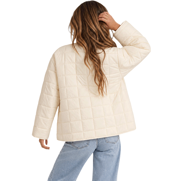 back of woman wearing bone colored jacket