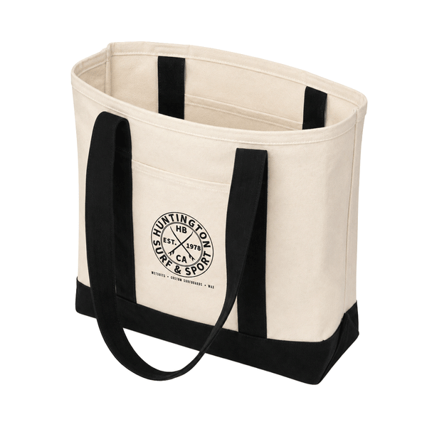 Huntington Surf & Sport natural canvas tote bag with black straps and logo. bag is open on white background