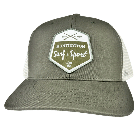 olive green and white trucker hat with white and green patch logo