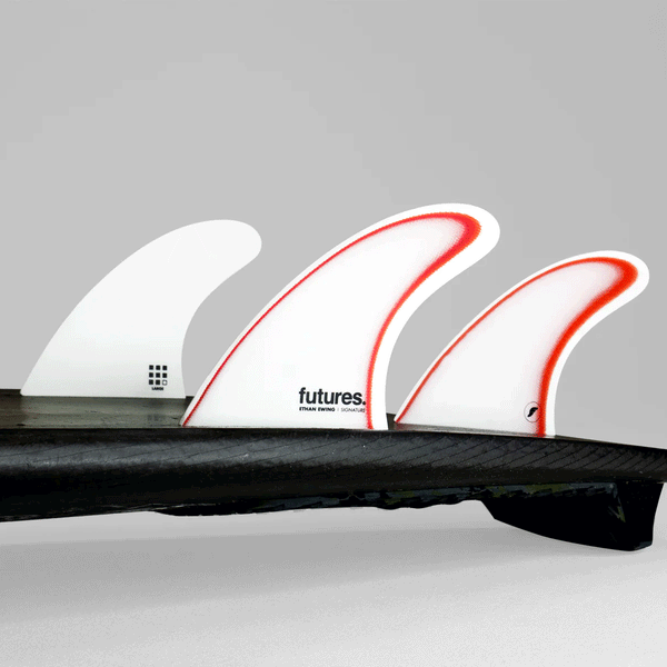 tail of surfboard with ethan ewing model fins on. 