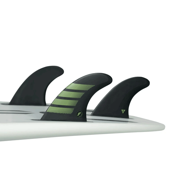 tail of white surfboard with 3 fins attached