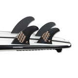 tail of white surfboard with 4 fins attached