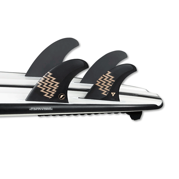 tail of white surfboard with 4 fins attached