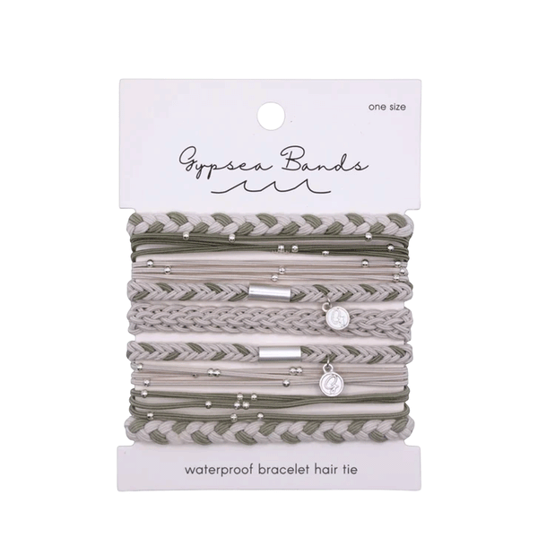 9 various Hair ties / bracelets that are all white and green colored