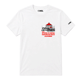 white US Open of Surfing t-shirt against a clean white background. The shirt features a small left-chest graphic of the Huntington Beach Pier with red rooftops and black linework above red text reading “US Open of Surfing Huntington Beach California.”
