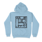 back of light blue hooded sweatshirt with silhouette of surfboards trees and waves
