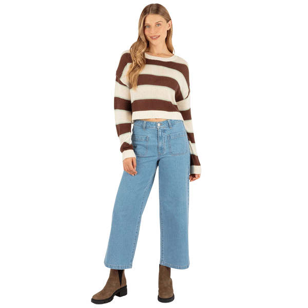 woman wearing brown and white striped cropped sweater with jeans