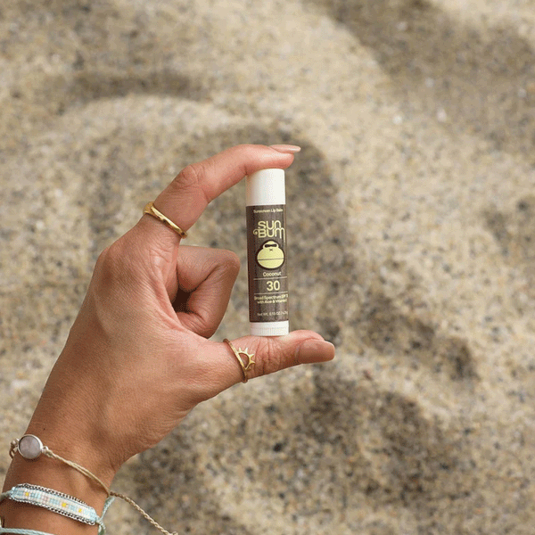 person holding lip balm stick