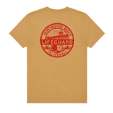 Back of tan Huntington Beach Lifeguard men's T-shirt with large red lifeguard emblem graphic.