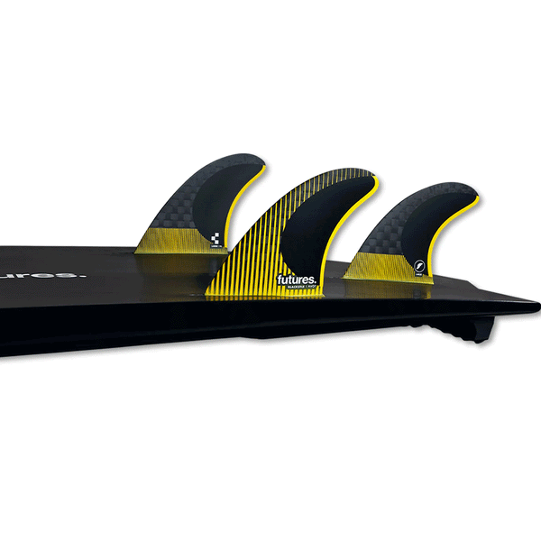 tail of surfboard with 3 fins attached