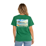 back of woman wearing green t-shirt with large image of the HB Pier on the back
