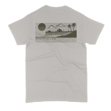 Gray t-shirt with a beach graphic and text on the back against a white background