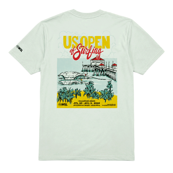 Back view of a light sage green men's T-shirt displayed on a clean white background. The shirt features a large, colorful "US Open of Surfing" graphic centered on the back, showcasing the Huntington Beach Pier, ocean waves, palm trees, and event branding in yellow, red, teal, and black. A small WSL logo is printed on the left sleeve. The design highlights the Huntington Beach, California surf event with a vibrant coastal illustration and retro-inspired typography.