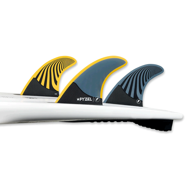 tail of surfboard with 3 surf fins attached