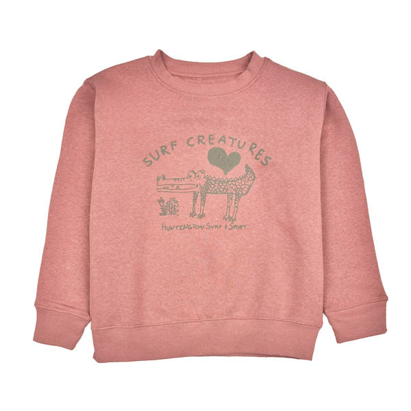 pink crew neck sweatshirt with cartoon drawing of a crocodile with text " Surf Creatures"