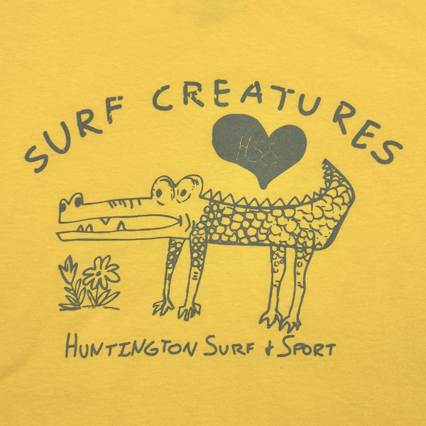 drawing of a cute crocodile with text "surf creatures"