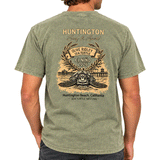 back of person wearing washed green t shirt with image of turtle and hb pier