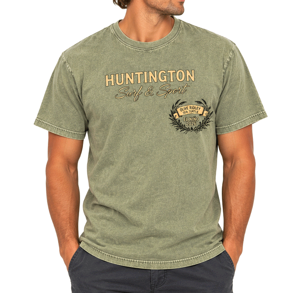 front of person wearing a washed green t shirt with a yellow text of Huntington surf & sport, Olive ridley Sea turtle
