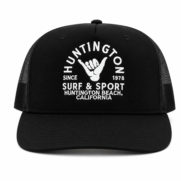black trucker hat with white embroidered logo on a white background