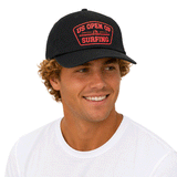 person wearing black hat with red US Open Shield logo on white background