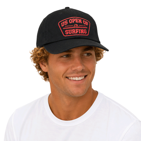 person wearing black hat with red US Open Shield logo on white background
