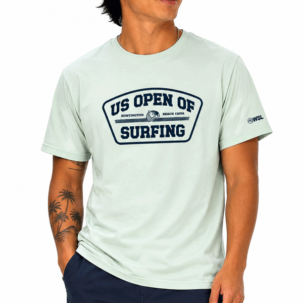 person wearing light green tshirt with grey US Open's Shield logo on white background