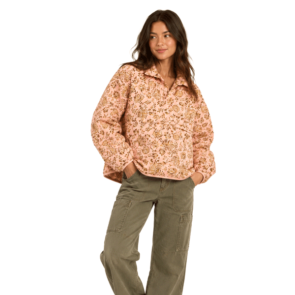 Person wearing pink nylon pull over jacket with flower print