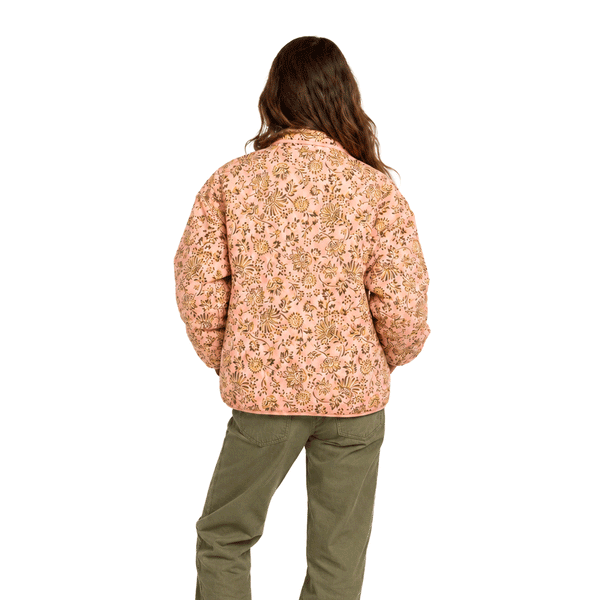 back of person wearing pink nylon pull over jacket with flower print