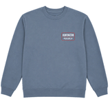 Slate blue Huntington Beach Surf Co. crewneck sweatshirt with small chest logo and large back graphic on a white background.