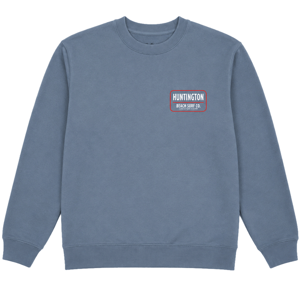 Slate blue Huntington Beach Surf Co. crewneck sweatshirt with small chest logo and large back graphic on a white background.