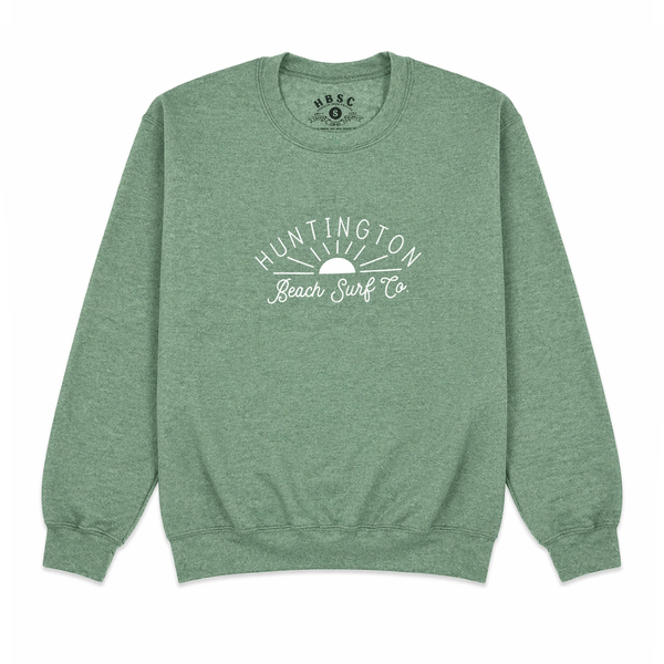 green crewneck sweatshirt with white script with sun. "huntington beach surf co."