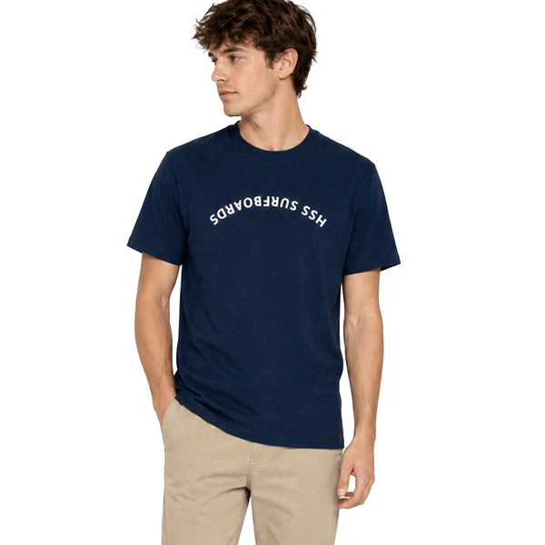person wearing blue t shirt with upside down text across chest "HSS Surfboards" on white background