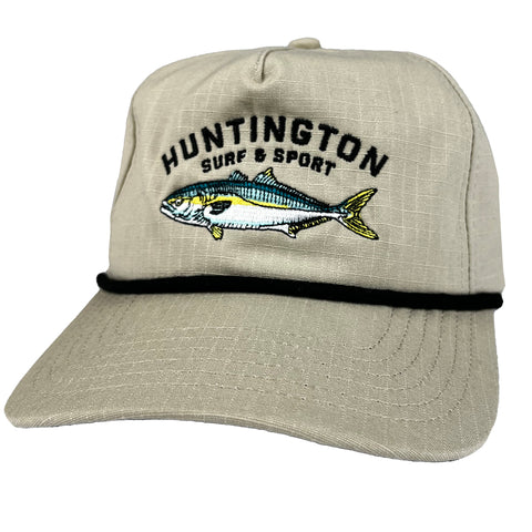 Beige cap with fish design and 'Huntington Surf & Sport' text on a white background