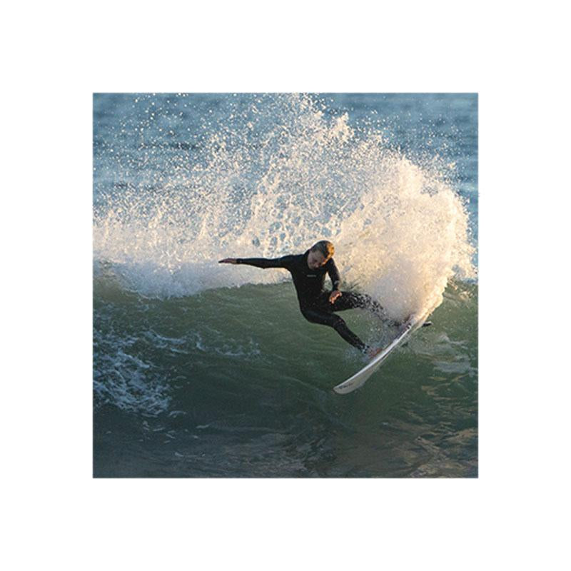 SURFER DOIN A TURN ON A WAVE